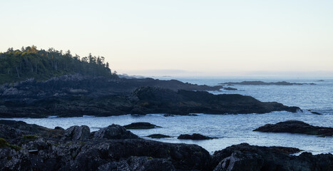 Rugged Rocks on a rocky shore on the West Coast of Pacific Ocean. Summer sunrise. Ucluelet, Vancouver Island, British Columbia, Canada. Nature Background