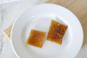 Fried pork skin on a white plate. Pig food culinary cuisine.