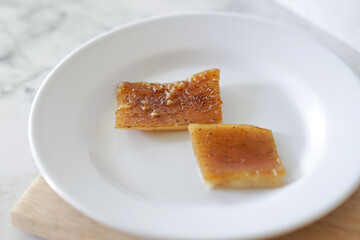 Fried pork skin on a white plate. Pig food culinary cuisine.
