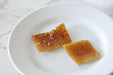 Fried pork skin on a white plate. Pig food culinary cuisine.