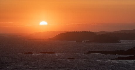 Waves on the Pacific Ocean on a rocky beach. West Coast. Sunny Summer Sunset. Cox Bay, Tofino, Vancouver Island, BC, Canada. Canadian Nature Background.