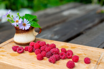 appetizing chamomile and raspberries lie on the board