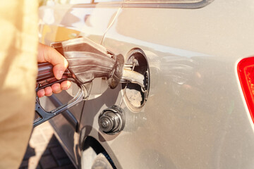 A man at the gas station filling the tank of his car with diesel to the top level before a long journey as fuel prices is going up