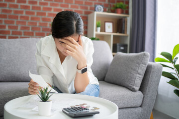 Asian women are stressed and confused about calculating expenses from invoices or invoices,  have...