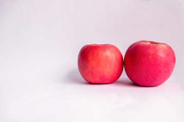 Fototapeta na wymiar Two Red Fuji Apples in White Isolated Background