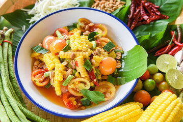 Salad corn spicy with yardlong bean and fresh vegetables herbs and spices ingredients with chilli tomato peanut garlic lemon lime served on plate, Menu Asian Thai food corn salad
