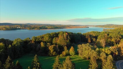 Drone shot of Hudson valley river in upstate new york with green trees and forest in a sunset 4K UHD 3840