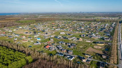 Foto auf Leinwand New rural neighbourhood Hout in Almere, The Netherlands, surrounded by nature. Aerial view. © Pavlo Glazkov