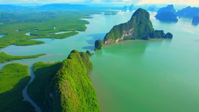 4K : Aerial view from a drone flying over Phang Nga Bay, beautiful many limestones peaks islands with its known the world over. (Samed Nang Chee), Phang Nga Province, Southern Thailand. Tropical sea
