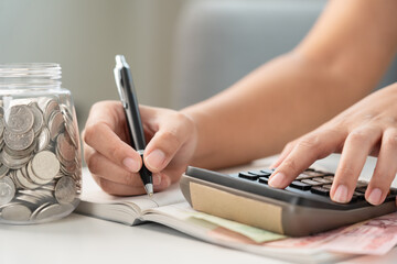 Woman calculating money coin for household saving