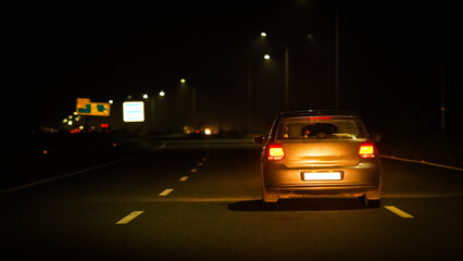 Obraz na płótnie Canvas white car in night on Highway road
