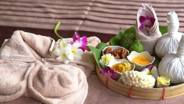 Spa massage wellness decorations setting on wood table. Thai spa massage traditional compress for hot massage and spa relaxing treatment of office syndrome. Massage for health concept.