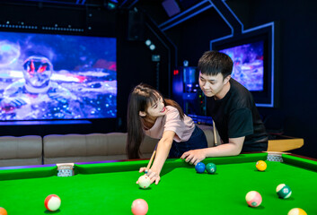 couple playing pool