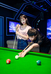 couple playing pool