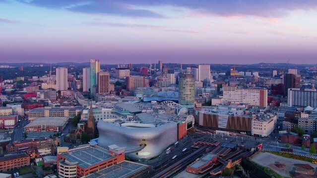 birmingham city downtown aerial view drone shot at dawn sunrise england uk,flying sideways over urban center