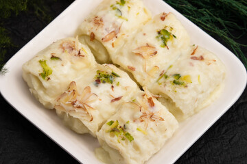 Indian Mithai Bread Malai Roll Rabdi Or Bengali Rabri Is Made Of Soft White Bread Slices, Dipped Soaked Or Dunked In Simmering Creamy Milk With Kesar, Khoya, Mawa, Mava, Khoa, Pista, Badam, Kaju