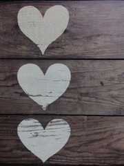 Three white hearts on rustik wood 