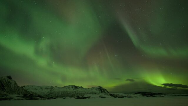 Powerful Burst of Northern Lights above Mountains in Northern Norway