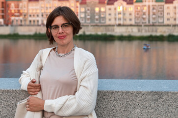 Portrait of a girl on the embankment of the river