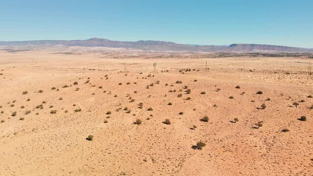 Top angle aerial view desert New Mexico Drone shot of western sand dunes and mountains with blue clear cloudless sky and brush steppe 4K UHD 3840