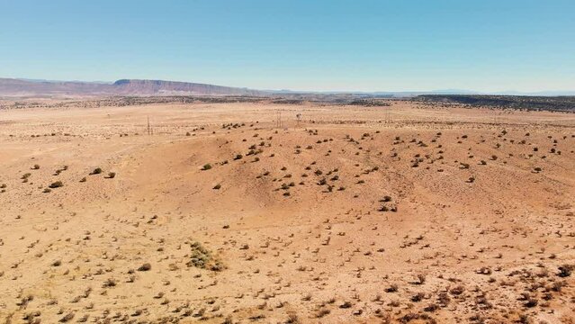 Top angle aerial view desert New Mexico Drone shot of western sand dunes and mountains with blue clear cloudless sky and brush steppe 4K UHD 3840
