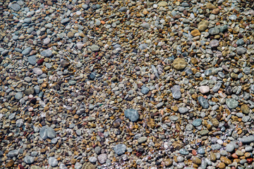 Waves on the seashore. A clear sunny day. Clear, clean sea water. Holidays on the coast. Natural background and texture.