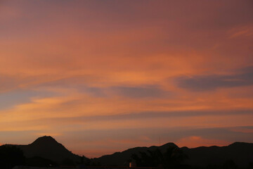 sunset over the mountain, sunset sky, purple sky, pink sky with mountain, pink orange sky