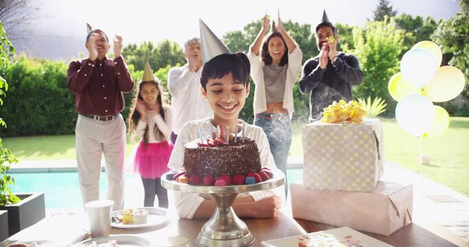 Children birthday party, birthday cake and candles for blowing out with mother, father and grandparents in home garden. Fun, excited or happy kids with smile clapping in celebration event with family
