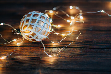 Close up of christmas ball with Chritmas tree lights flickering in background. shallow depth of...