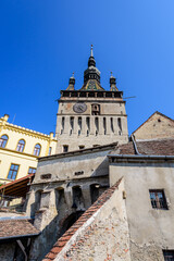 Fototapeta na wymiar The The Clock Tower or the Council Tower of the medieval citadel in the old center of Sighisoara, a UNESCO World Heritage Site in Transylvania (Transilvania) region, Romania, in a sunny summer day.