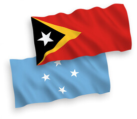 National vector fabric wave flags of Federated States of Micronesia and East Timor isolated on white background. 1 to 2 proportion.