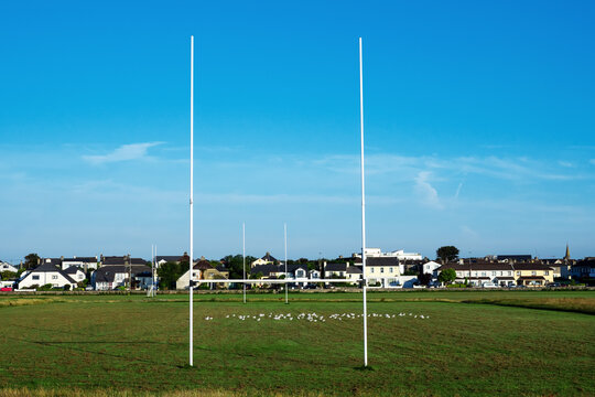 Green grass in a field and tall goal posts for Irish National sports in a field of the South park, Galway city, Ireland. Rugby, hurling, camogie and Gaelic football training ground. Nobody.