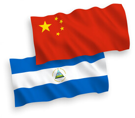 National vector fabric wave flags of Nicaragua and China isolated on white background 1 to 2 proportion.