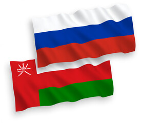 National vector fabric wave flags of Sultanate of Oman and Russia isolated on white background. 1 to 2 proportion.