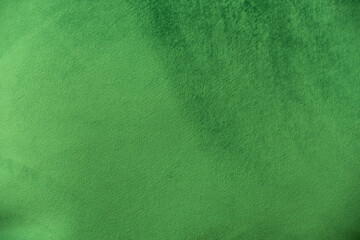 Green velvet fabric surface from above. velvet texture gold color background. expensive luxury fabric, material, wallpaper.