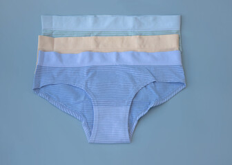 Women's multicolored panties lie on a blue background underwear