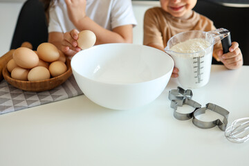 Happy children in the kitchen make cookies. Cooking master class