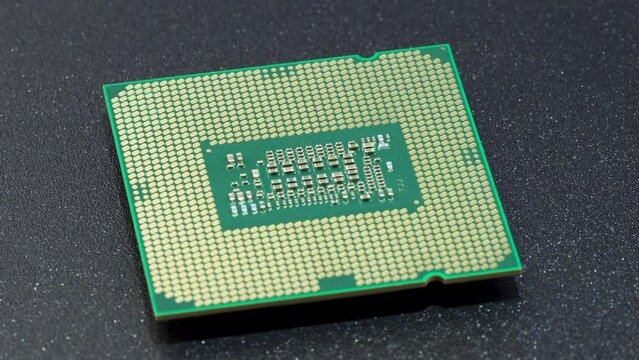 Computer CPU chip rotating - close up video. Shallow field of view. Macro shot of technology background.