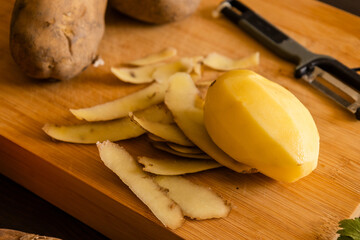 potatoes close up on wooden board at the kitchen table