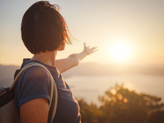 Fototapeta premium Travel to Turkey, viewpoint over Dalyan Iztuzu Beach. . Smiling woman taking break on hiking trip looking at view at sunset. Explore natural wonders of Turkey