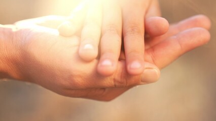 mother holds the hand of a newborn. close-up of a children hand. hospital takes care of happy family concept. newborn baby holding mom hand close-up. medicine mom takes care of baby in hospital