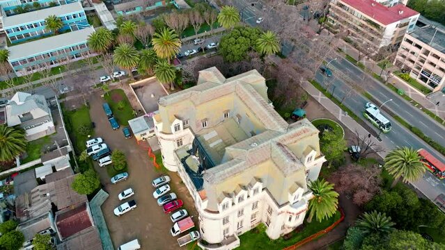 Aerial dolly in of Frech Style Carrasco Palace surrounded by palm trees Viña del Mar, Chile