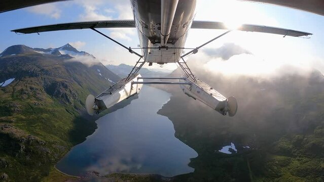 Alaska Bush Plane Flying Over Mountain Range