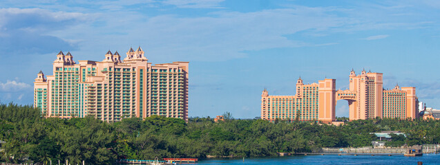 Panoramic view of Atlantis buildings in Nassau, The Bahamas, with blue skies near a coastline |...