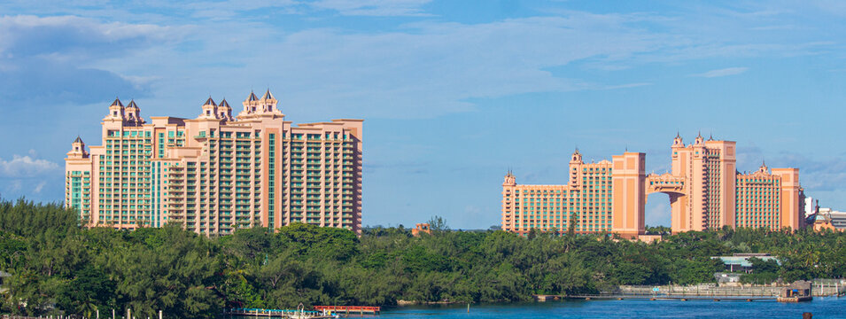 Panoramic view of Atlantis buildings in Nassau, The Bahamas, with blue skies near a coastline | Replica of Atlantis buildings in Nassau, Bahamas Image Background 