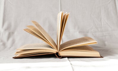 Open book. Turning pages on white background. Reading, education, intellectual development, knowledge-enhancement concept. High quality photo