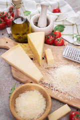 Parmesan cheese and grater on a wooden cutting board
