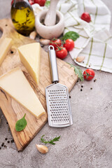Parmesan cheese and grater on a wooden cutting board