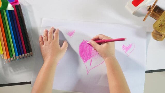 Asian cute kid preschool smiling draw creative hearts love picture at home, Happy child little girl colorful drawing pink heart on white paper, Valentine day or Mother or Fathers Day, art education