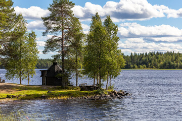 Arvidsjaur, Sweden A small hut that is used as a sauna next to a lake.